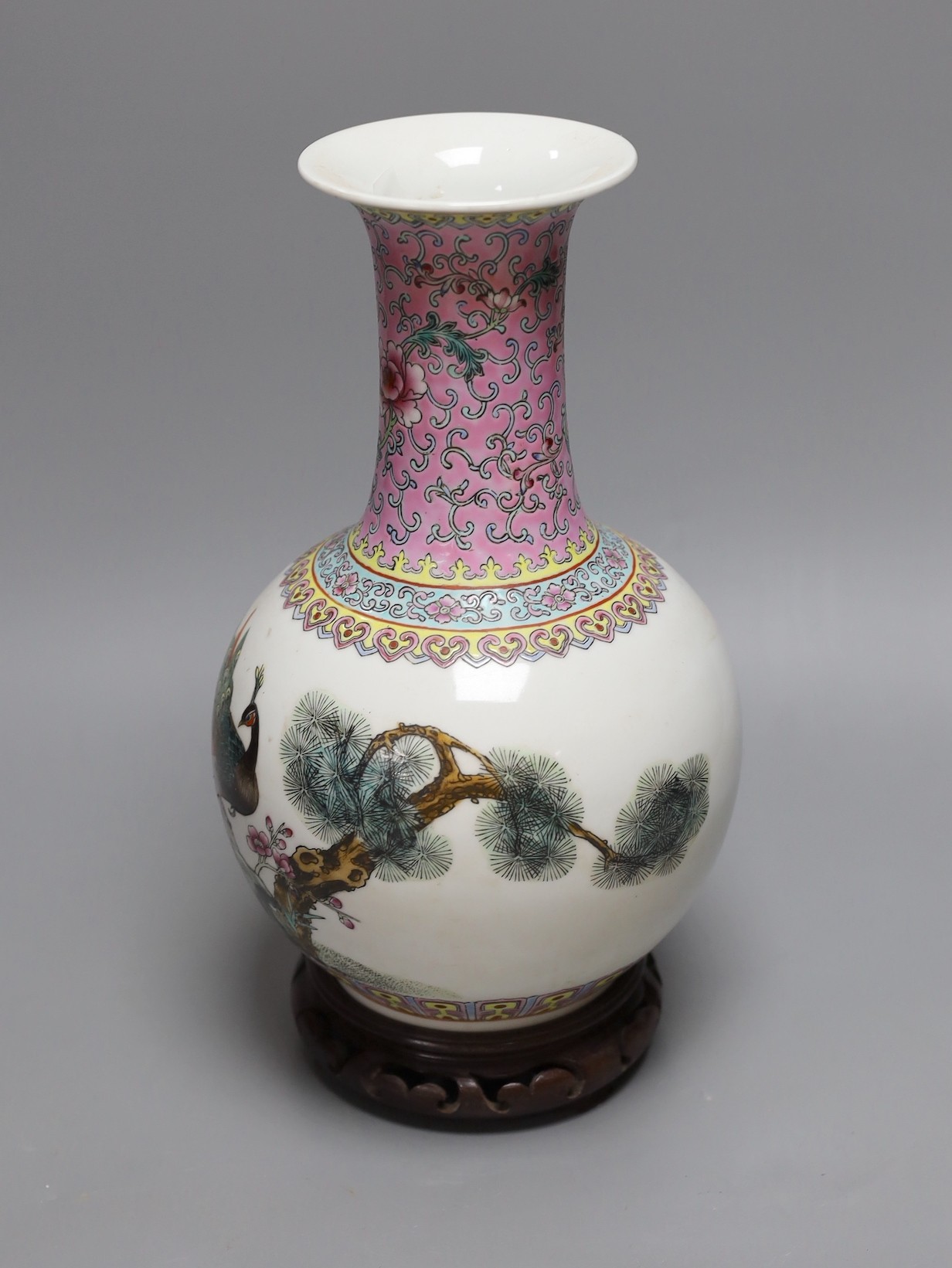 A Chinese famille rose vase, 27cm, on carved wood stand